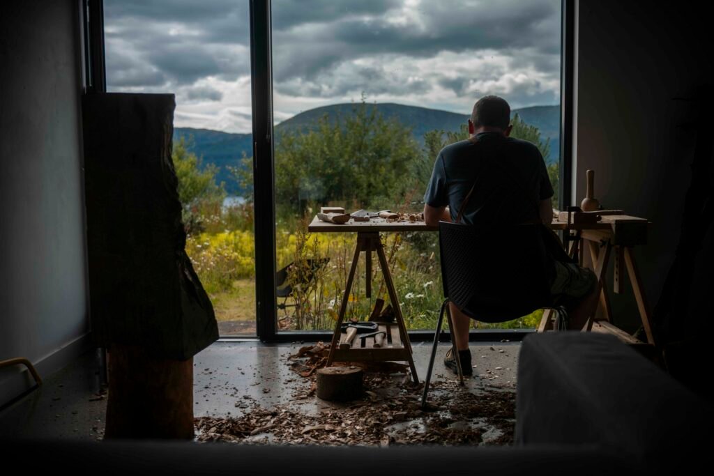 Sam Kilday carving wood at Cove Park
